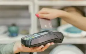 bancnet user tapping their card on a payment machine, making a secure and contactless transaction through bancnet's payment system